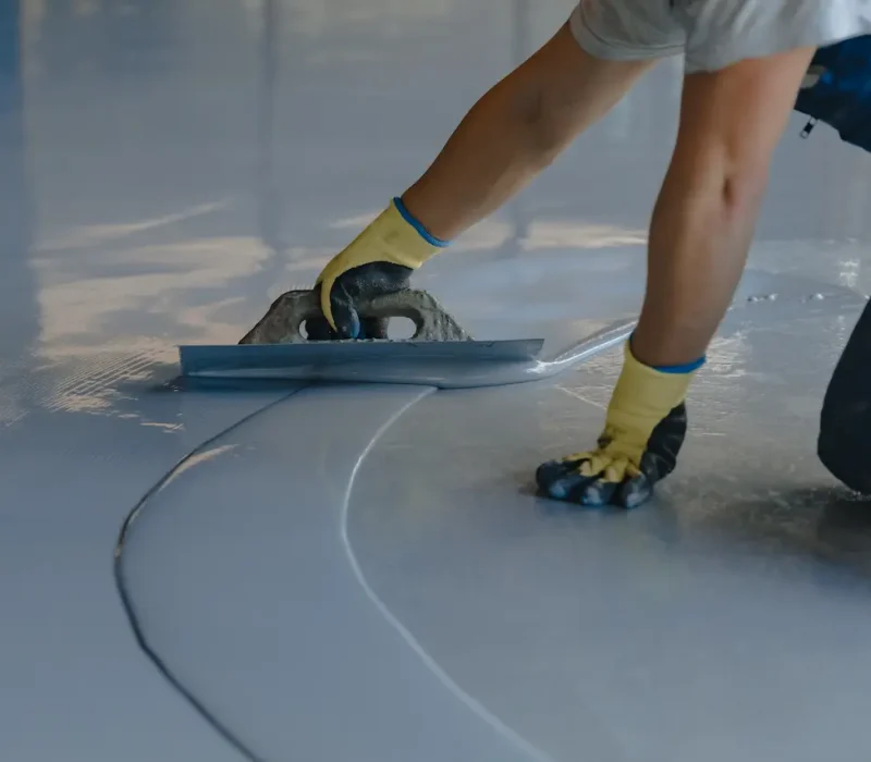 skilled-worker-applying-resin-coating-on-floor-2026-01-09-11-46-09-utc